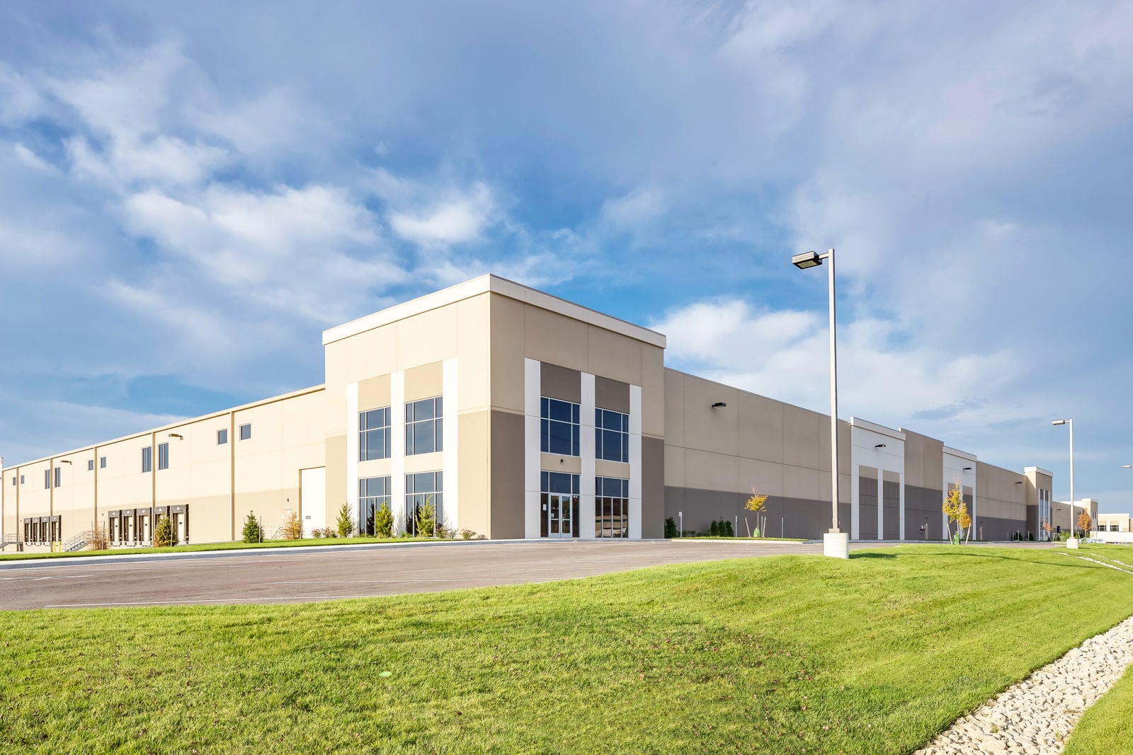 Warehouse exterior with loading docks, office entrance and landscaped frontage