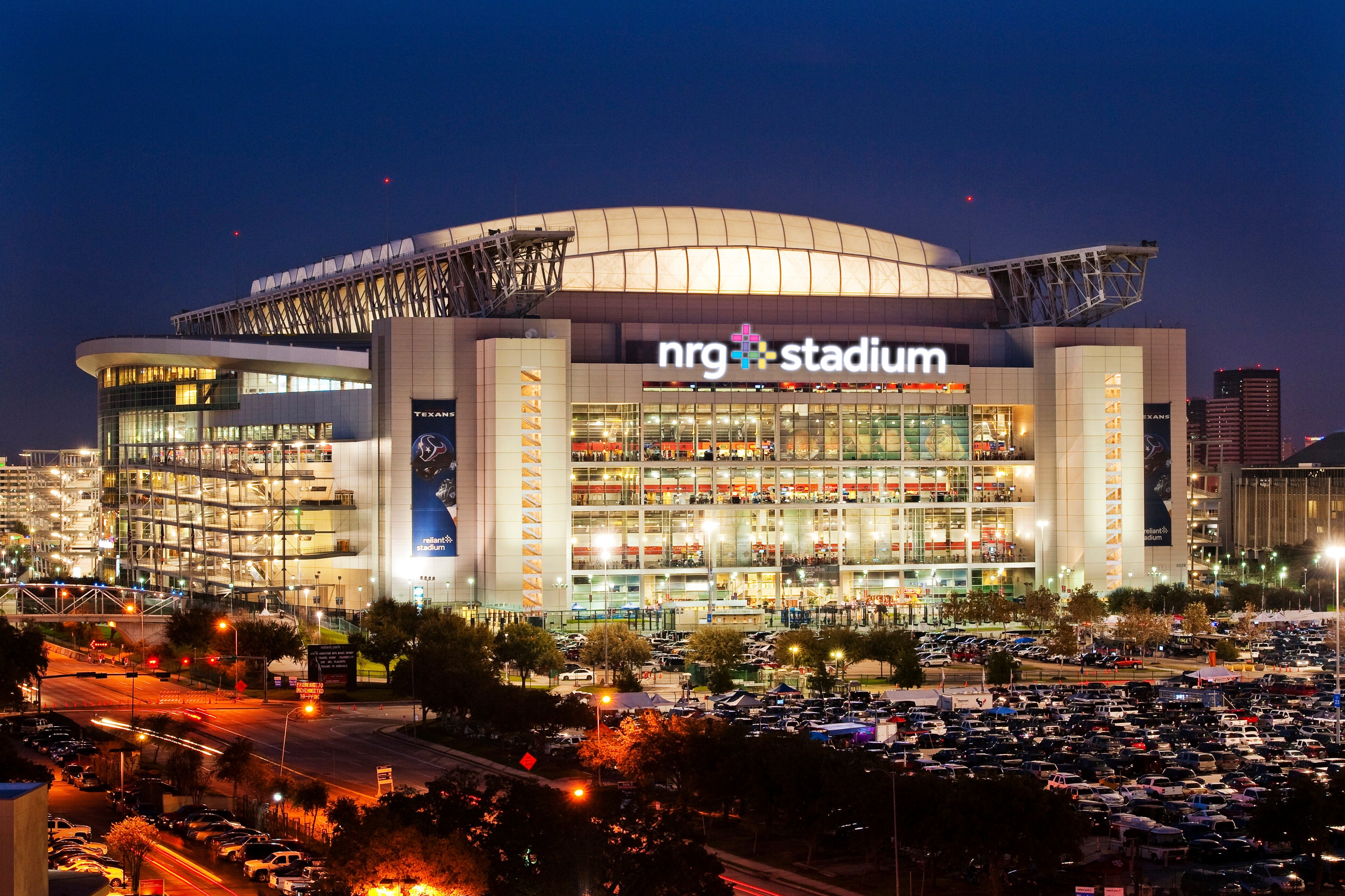Houston Texans stadium exterior at night, pictured with NRG Stadium signage